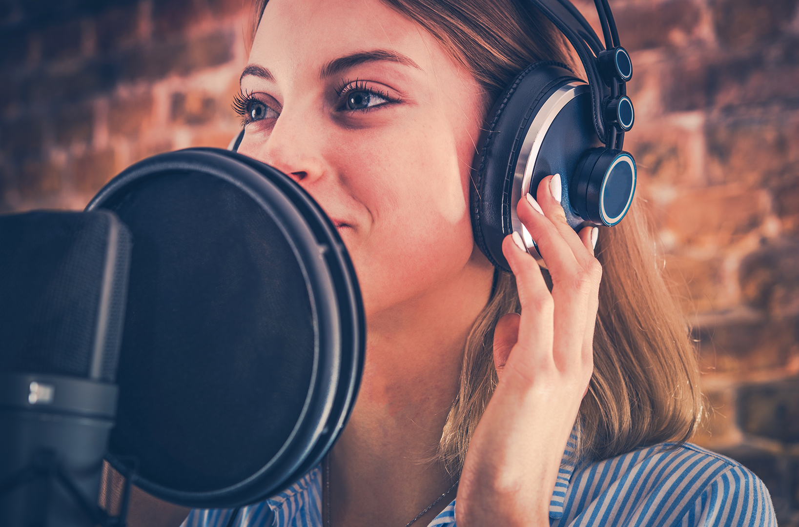 Woman recording audio with a professional microphone and headset